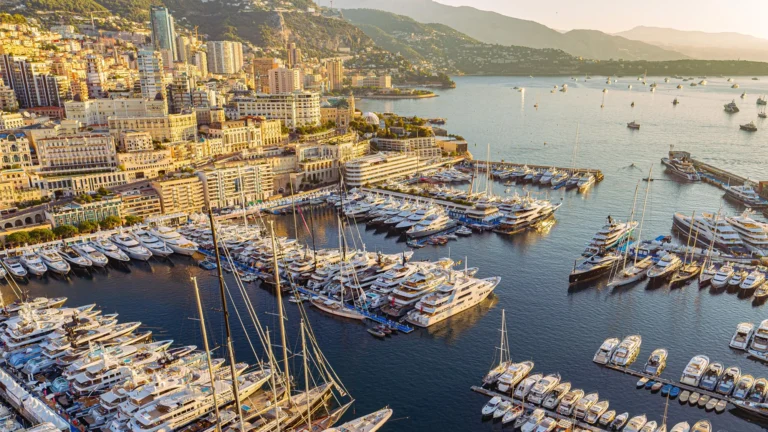 Golden-hour aerial of Port Hercule packed with superyachts — Monaco Yacht Show